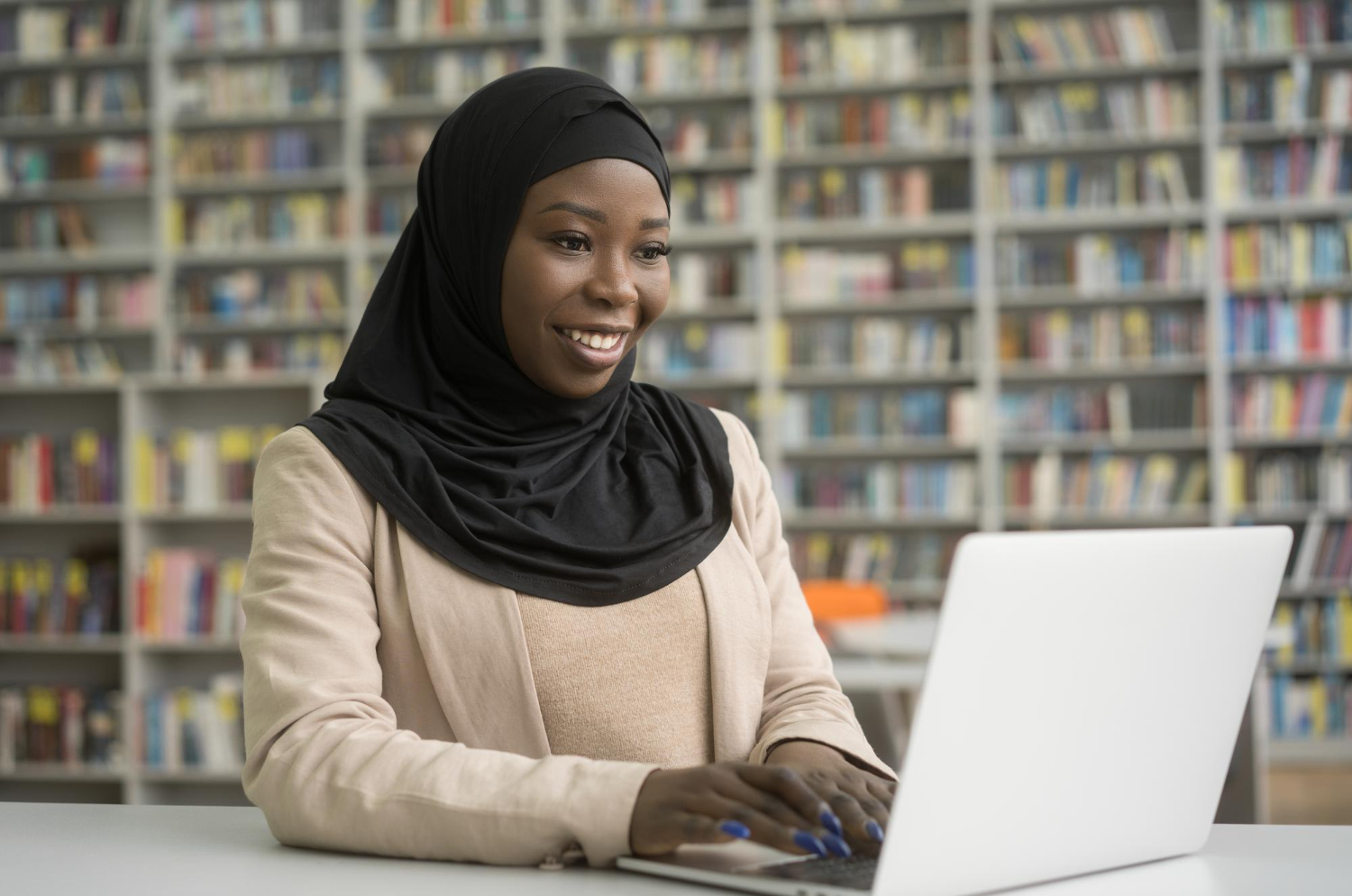 Professional studying online at a library desk