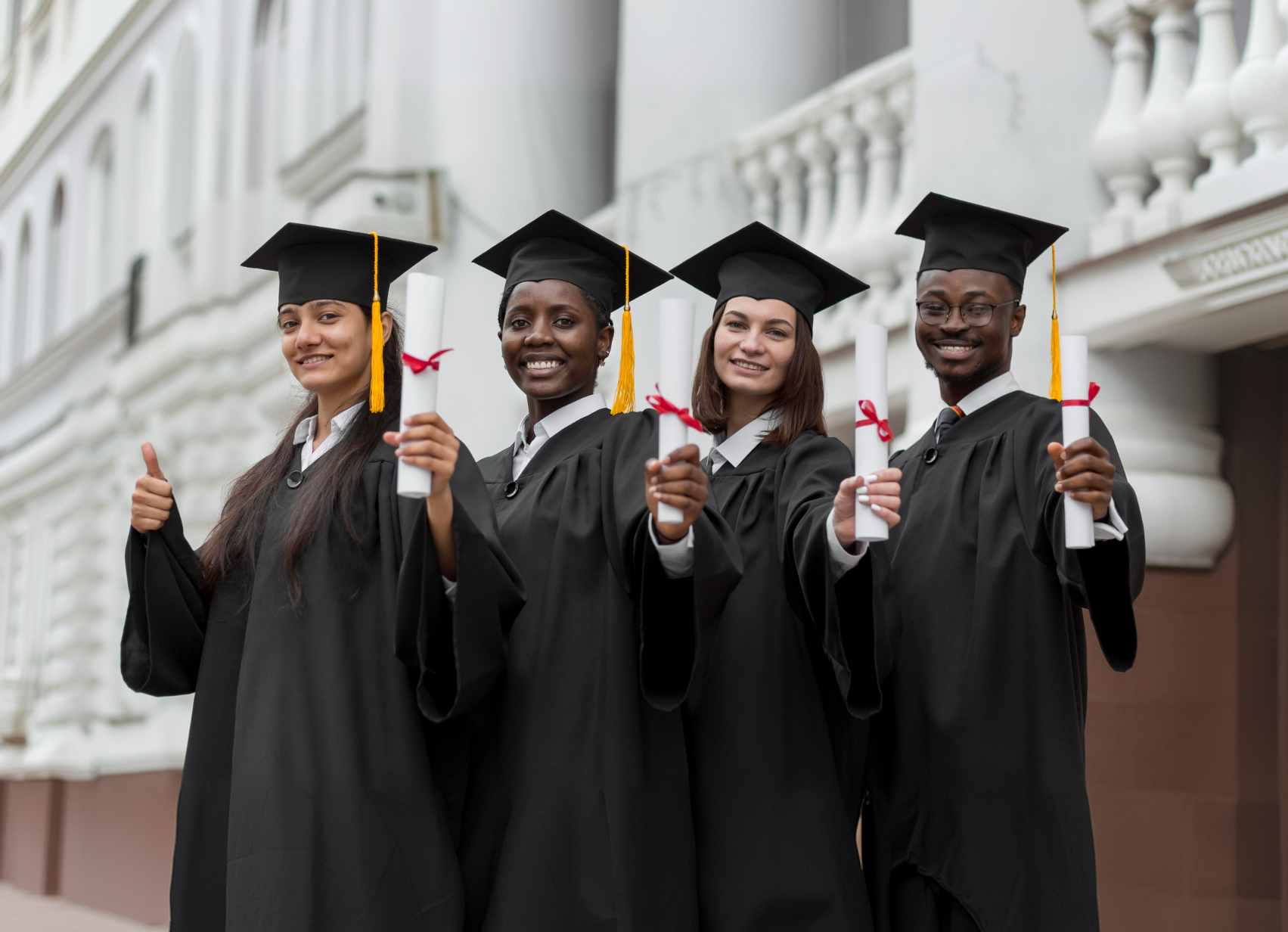 Graduates celebrating with their diplomas